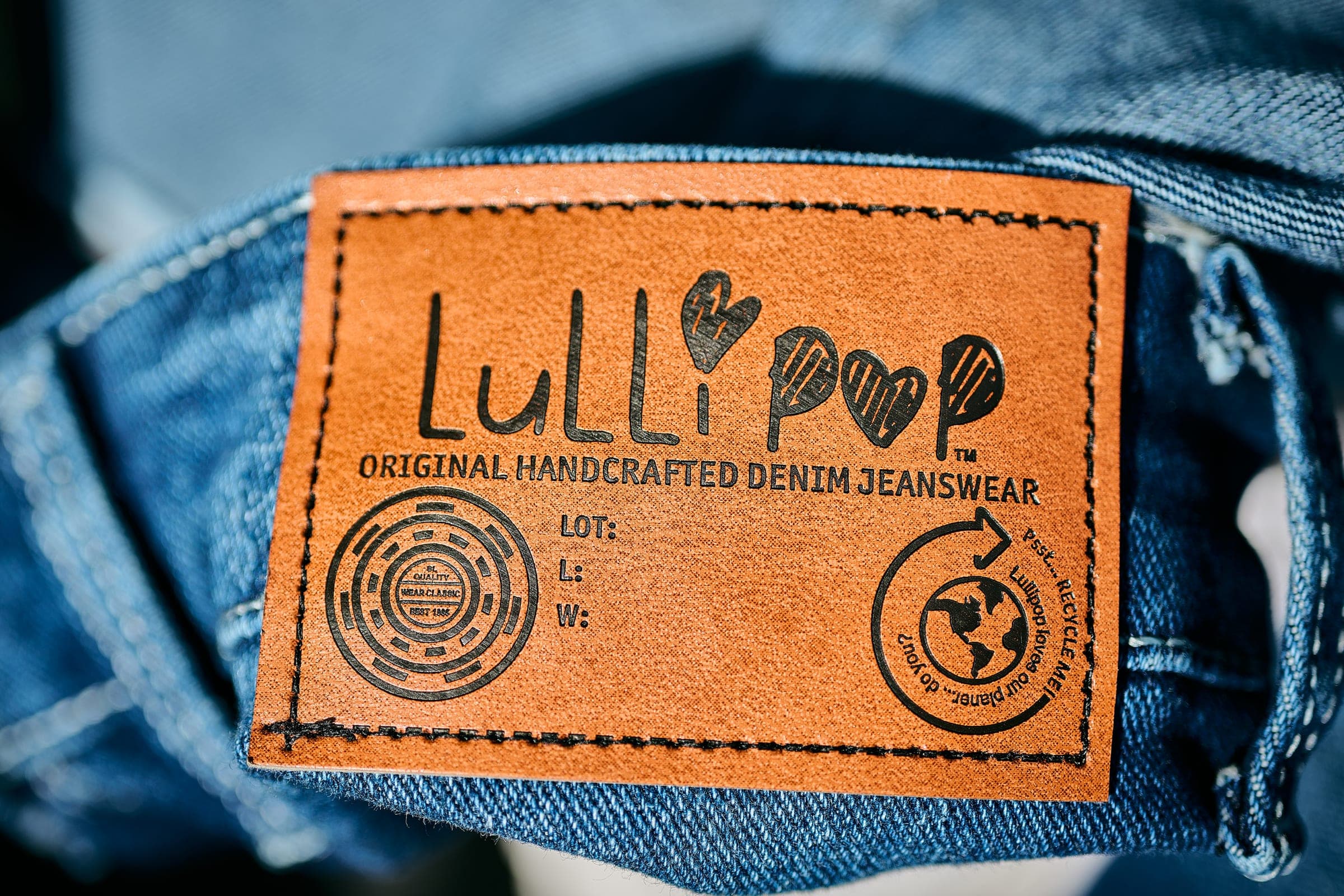 Close-up of the Lullipop label and denim stitching