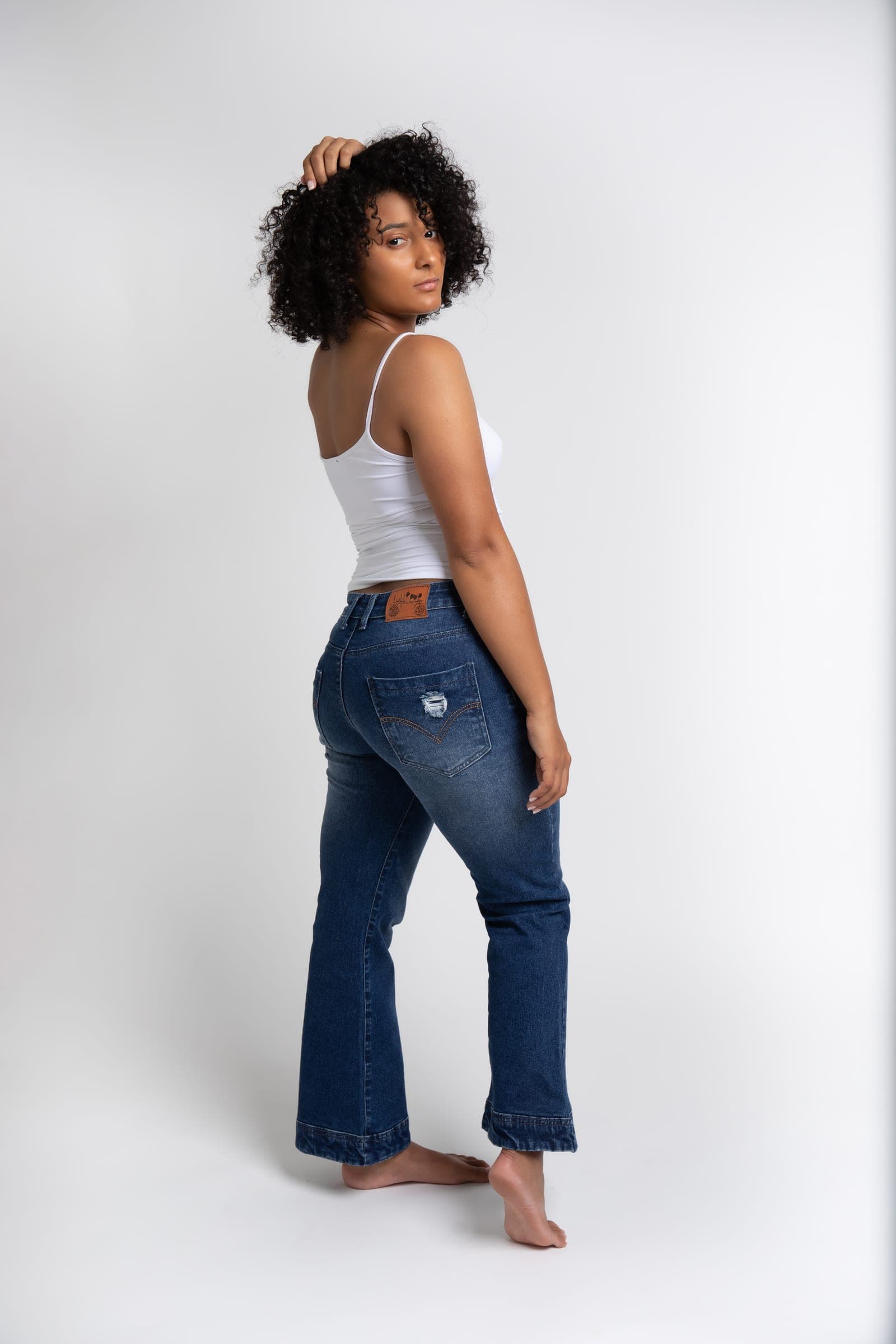 Lullipop Jeans worn with a white tank, full length, three-quarter back view